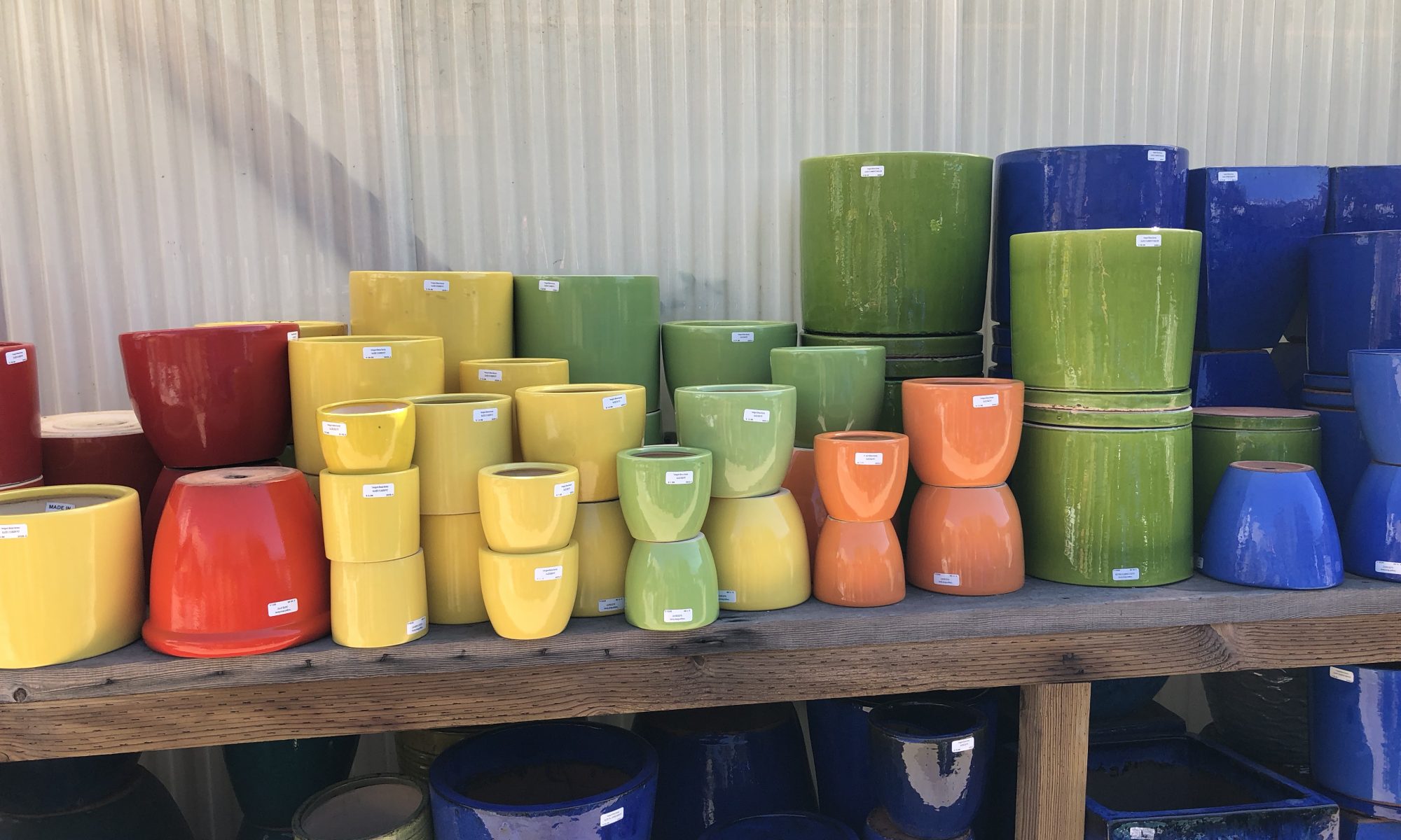 Colorful glazed pottery lined up in the yard